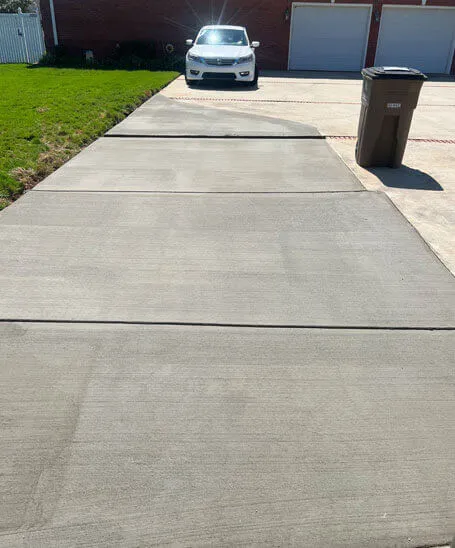 Concrete driveway leading to a two-car garage installed by Battle Concrete in Huntsville, AL