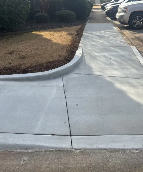 Curved concrete driveway extension with a parking pad completed in Madison, AL