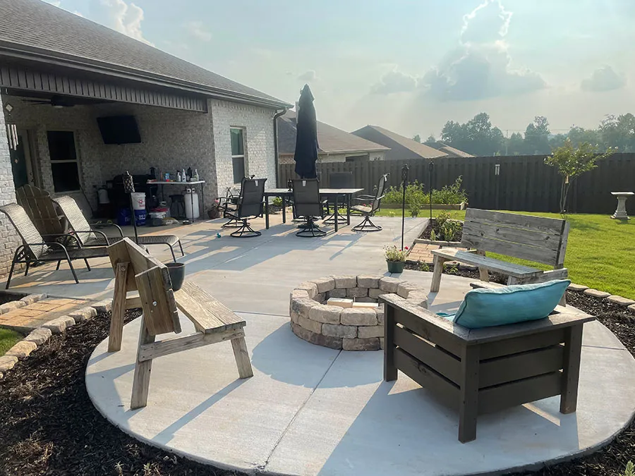 Concrete patio with a stone fire pit and seating area completed in Meridianville, AL