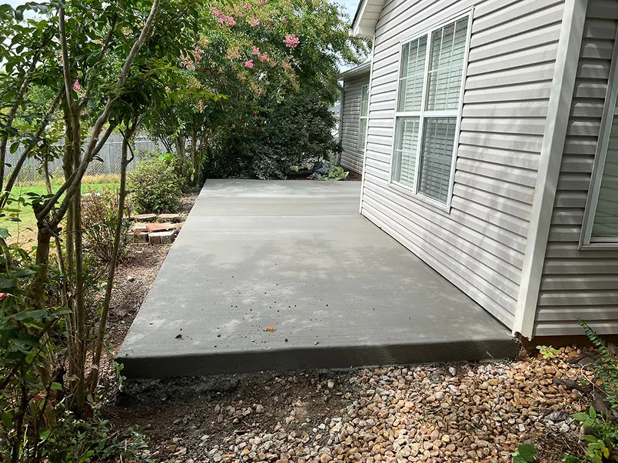 Concrete slab addition poured alongside a vinyl-sided home in Madison County, AL