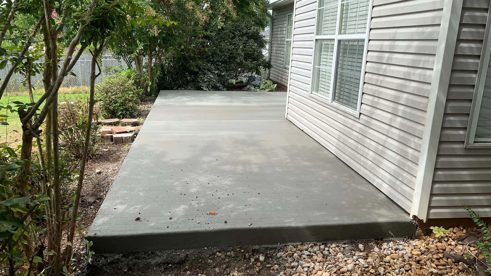 Newly poured concrete patio slab alongside a home in Huntsville, AL